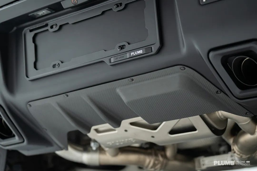 PLUMB M-One Defender L663 rear bumper close-up