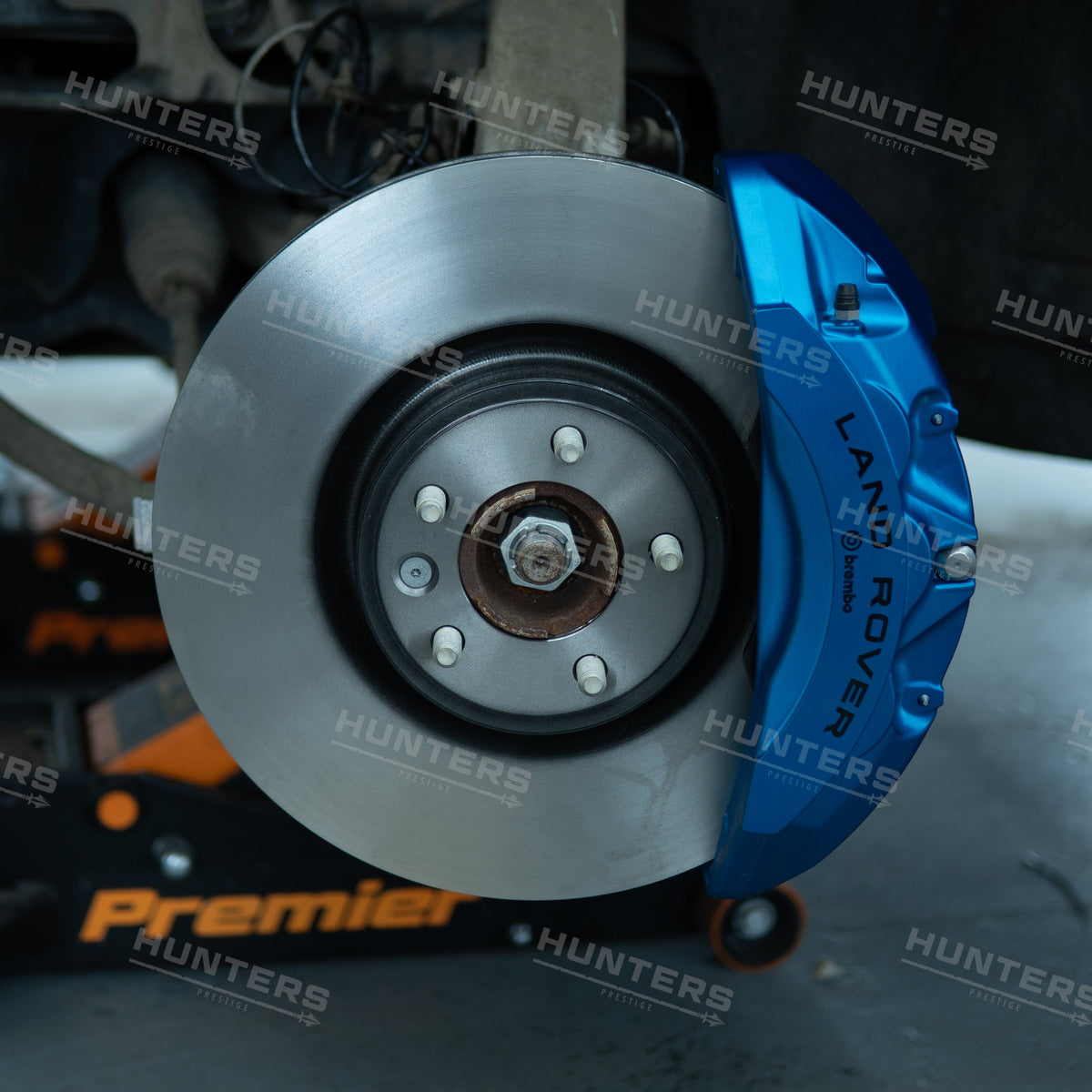 Genuine Land Rover front brake upgrade shown fitted with blue caliper